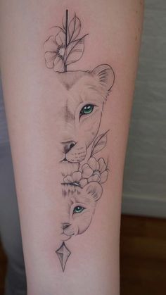 a woman's thigh with an animal tattoo on the side of her leg, and flowers