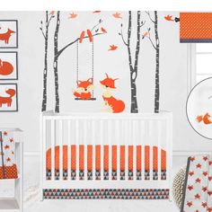 a baby's nursery room with an orange and gray theme, including fox wall decals