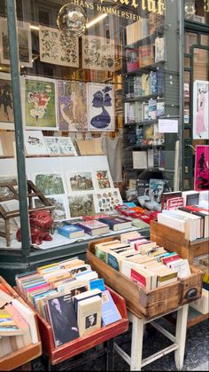 a store front with lots of books on display in it's glass window case