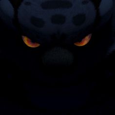 an animal's face with yellow eyes is shown in this dark photo, it appears to be glowing