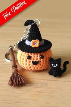 a crocheted pumpkin keychain with a witch hat and cat on it