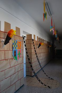 several pieces of paper are taped to the wall with chains and flags hanging from them