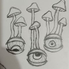 the drawing shows three different types of mushrooms and eyes, with one being drawn in pencil