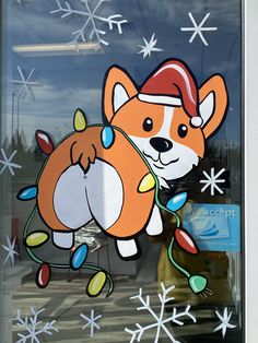 a glass window with a cartoon dog on it's side and snowflakes in the background