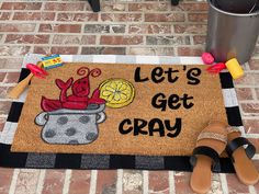 a door mat that says let's get cray on it next to sandals and a trash can