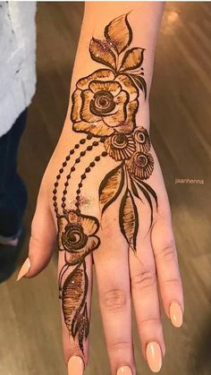 a woman's hand is decorated with hennap and flower designs on it