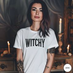 Embrace your witchy side with our Witchy Shirt. This Retro Witchy Vibes Shirt features a lightly distressed font for that perfect vintage look, ideal for spooky season or embracing witchy aesthetics year-round. Whether you're celebrating Halloween or simply love the witchy woman vibe, this shirt is a must-have addition to your wardrobe. It also makes a thoughtful gift for any mystical soul. Would you prefer this design on a Sweatshirt? Have a look at our other listings here: https://www.etsy.com Fitted Fairy Grunge Tops For Halloween, Crew Neck Shirt For Halloween Alternative Fashion, Fairy Grunge Halloween Crew Neck Top, Fitted Witchy Top For Halloween, Fairy Grunge Crew Neck Top For Halloween, Gothic Letter Print Tops For Fall, Halloween Fairy Grunge Tops, Witchy Cotton Tops With Letter Print, Edgy Cotton Halloween Shirt