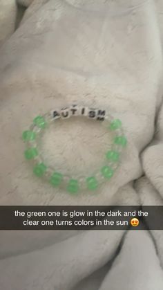 a green bracelet that says, the green one is glow in the dark and the clear one turns colors in the sun