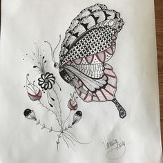 a drawing of a butterfly on top of a piece of paper with flowers around it