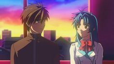 two anime characters standing next to each other in front of a cityscape at sunset