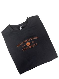 Halloweentown University Embroidered Unisex Crewneck Sweatshirt. Customize your item with your choice of shirt color and thread color. Primary Color option is the shirt.   No returns or exchanges on customized items. Please contact me at any time for concerns about your purchase. Black College Sweatshirt With Embroidered Text, Collegiate Crew T-shirt For Fall, Fall College T-shirt With Embroidered Logo, Embroidered Fall College T-shirt, Fall College Embroidered Tops, College T-shirt With Embroidered Logo For Fall, Embroidered Graphics T-shirt For College In Fall, Embroidered Text T-shirt For College In Fall, Black T-shirt With Embroidered Logo For Fall