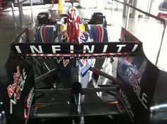 the front end of a race car in a showroom