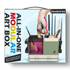 an art box with various paints and brushes in it, including one person's hand