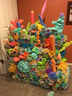 a large pile of colorful paper machs sitting on the floor