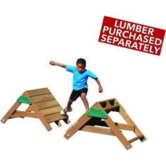 a young boy is jumping on a wooden play set with a sign that says lumber purchased separately