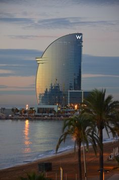 a very tall building sitting next to the ocean