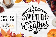 some autumn leaves and pumpkins on a white wooden background with the words sweater weather