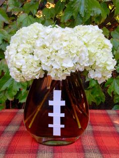 a vase filled with white flowers on top of a table