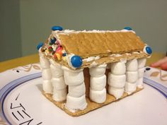 a house made out of marshmallows on a plate