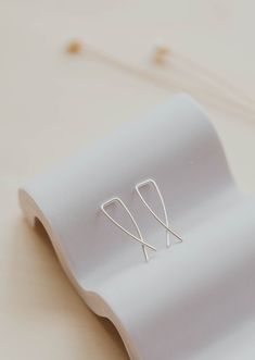 These sweet little MINIs measure just under 1” and thread right through your piercing - no backs necessary. Wire is hand-shaped and left round (un-hammered) for a sleek look. Measures just under 1" long. The gauge of these earrings is 18g which is slightly thicker than the average ear wire. They will fit most piercings but may be uncomfortable for very sensitive ears. Sold as a pair. Available in 14kt Gold Fill + Sterling Silver. Handmade in Eau Claire, WI. Our jewelry is handmade so each piece Minimalist Silver Threader Earrings In 14k Gold, Adjustable Sterling Silver Ear Climbers For Everyday, Small Hammered Adjustable Hoop Earrings, Delicate Hypoallergenic Sterling Silver Threader Earrings, Adjustable Minimalist Sterling Silver Ear Climbers, Nickel-free Sterling Silver Threader Earrings, Modern Nickel-free Sterling Silver Threader Earrings, Minimalist Nickel-free 14k Gold-filled Threader Earrings, Minimalist Sterling Silver Nickel-free Ear Climbers