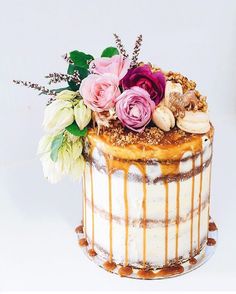 a cake with flowers and nuts on top