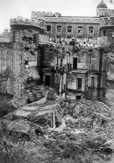 black and white photograph of an old building that has been torn down with debris on the ground