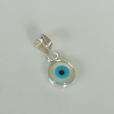 ▪︎ Tiny sterling silver evil eye charm/ pendant. ▪︎ Size: 6 x 9 mm Jump ring: 5 mm ▪︎ This is a multi functional charm and can be used with neck chains, ear hoops, bracelets, anklets, key chains etc. ▪︎ This pendant is handmade with hypoallergenic sterling silver, and is nickel free. Comes with a 925 mark for authenticity. ▪︎ Please note: Price listed is for ONE charm. This pendant comes WITHOUT the chain, however, you can add a snake neck chain, bracelet chain or hoop in the required size while Spiritual White Sterling Silver Charm Necklace, White Sterling Silver Spiritual Charm Necklaces, Spiritual Round Pendant Charms As Gifts, Evil Eye Pendant Jewelry For Good Luck, Sterling Silver Evil Eye Teardrop Jewelry, Sterling Silver Teardrop Evil Eye Jewelry, Sterling Silver Round Pendant Charm Necklace For Good Luck, Handmade Good Luck Pendant Charm, Sterling Silver Charm Necklace For Good Luck