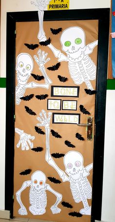 a classroom door decorated with skeletons and bats