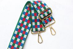 Adjustable multicolored (green, red, blue and white) checkered print purse strap . Pair this with your favorite crossbody messenger bag, purse, tote bag or handbag. This strap is also the perfect addition for game day or to show off your school spirit. 👜 Strap Details: - Adjustable length 30 - 54 inches (including clasps) - 2 inches wide - GOLD hardware - Design is shown on both sides of the strap Check out our other colors in this design 👇  https://www.etsy.com/shop/ShopAvalee?section_id=42113202 📦 Fast Shipping daily Mon-Fri Green Adjustable Rectangular Bag Strap, Green Rectangular Shoulder Bag With Adjustable Straps, Plaid Rectangular Shoulder Bag With Adjustable Strap, Checkered Bag, Strap For Bag, Printed Purse, Checkered Print, Purse Strap, Crossbody Messenger Bag