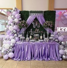 a purple and silver dessert table with balloons