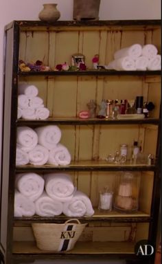 a shelf filled with lots of white towels