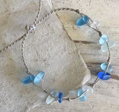 Channel your inner mermaid with this gorgeous beach bracelet or anklet made with mixed blues and white sea glass pebbles on our durable hand spun rope cord. Pure island style! Easy and secure adjustable slide knot closure allows for easy on and off. This bracelet/anklet is completely waterproof and metal free making it perfect for anyone with skin sensitivities and is a wonderful and unique gift for those hard to shop for friends and family on your list, especially the beach lovers! Color: Mixed Handmade Adjustable Sea Glass Bracelets, Adjustable Blue Jewelry Made Of Recycled Glass, Adjustable Blue Jewelry With Recycled Glass, Adjustable Blue Recycled Glass Jewelry, Beach Jewelry Blue Hand-wrapped, Blue Hand Wrapped Jewelry For The Beach, Hand Wrapped Blue Jewelry For Beach, Beaded Sea Glass Jewelry For Beach, Adjustable Recycled Glass Beaded Bracelets For Beach