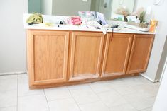 a bathroom vanity with lots of clutter on it