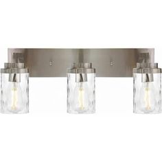 three light bathroom fixture with clear glass jars on the front and back of the lights