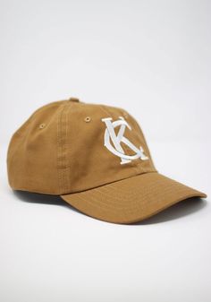 This Kansas City Brown Adjustable Hat features a front embroidered team logo on a cotton unstructured crown with pre-curved visor and adjustable closure. Sandlot Goods Dad Hat, Front embroidered logo, Six panel design with eyelets, Cotton twill material, One size most most, Cotton, Wipe clean with cloth or cleaning kit, 4 Cotton Baseball Cap With Logo, Cotton Hat With Logo And Curved Visor, Cotton Six-panel Hat With Logo, Cotton Hat With Curved Visor And Logo, Cotton Curved Visor Hat With Logo, Collegiate Adjustable Trucker Hat With Curved Brim, Cotton Baseball Cap With Curved Brim And Logo, Classic Baseball Cap With Logo Curved Brim, Classic Dad Hat With Logo And Curved Bill