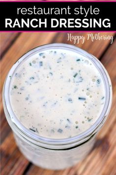 a mason jar filled with ranch dressing on top of a wooden table