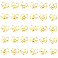 gold colored bows and rings are arranged in rows on a white background, with the word love