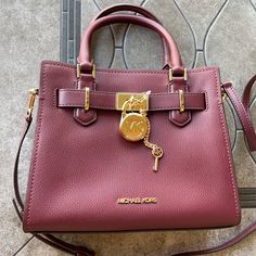 Michael Kors Hamilton Small Satchel Shoulder Crossbody Bag Pebbled Leather Dark Cherry Nwt Authentic Michael Kors Logo At Front Zip Top Closure Gold Toned Hardware Mk Key & Lock On Front Custom Mk Fabric Lining 1 Slip-In Pockets 1 Zipper Pocket 10" (L) X 8"(H) X 4"(D) Strap: 4", 18"- 24" Very Clean, Smoke-Free And Pet-Free Environment Mk Tote Bag, Michael Kors Satchel, Michael Kors Logo, Silver Bags, Black Leather Satchel, Bag Dark, Leather Satchel Bag, Key Lock, Satchel Purse