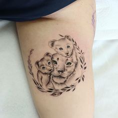 a woman's thigh with a tattoo of two koalas and an elephant