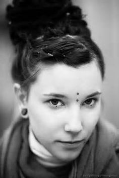 a black and white photo of a woman with braids in her hair