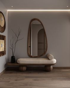 a large mirror sitting on top of a wooden shelf next to a white bench in a room