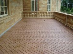 a brick patio with railings and windows