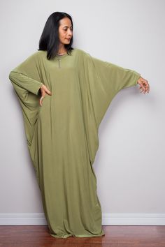 "Olive Green Kaftan Dress, Maxi Dress, Long boho dress, Loose fit dress, Modest dress, Green kaftan with pockets PRODUCT SIZE : One Size Fits Most * Chest : free up to 58\" * Waist : free up to 58\" * Hips : free up to 58\" * Circumference bottom hem : 45\" * Length : 56\" * Sleeve length : 23\" MATERIAL * Spandex Venetia * Zipper on the back MODEL : * Model chest : 32\", Height 160 cm (5.2) without high heel * Accessories excluded Produced by NUICHAN IMPORTANT NOTE *Please note that colours sho Green Maxi-length Abaya For Spring, Spring Green Maxi Length Abaya, Green Boho Tunic Dress, Oversized Maxi Length Abaya For Spring, Bohemian Maxi Length Green Abaya, Casual Long Green Maxi Dress, Bohemian Green V-neck Abaya, Green Flowy Long Kaftan, Green Long Flowy Kaftan