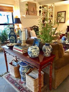 a living room filled with lots of furniture and vases on top of a table