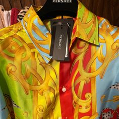 Beautiful Versace Shirt, Very Soft Silk Material, 100% Authentic,, Willing To Negotiate On The Listing Price, Willing To Trade For An Authentic Louis Vuitton Monogram Keepall 55 Or 60 Luggage Bag!!! Designer Multicolor Silk Shirt, Designer Multicolor Printed Tops, Designer Multicolor Graphic Print Blouse, Designer Multicolor Print Summer Tops, Designer Multicolor Print Tops For Summer, Designer Short Sleeve Multicolor Shirt, Designer Multicolor Summer Shirt, Designer Multicolor Graphic Print Tops, Designer Multicolor Printed Shirt