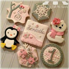 decorated cookies are arranged in the shape of animals and snowflakes, including one penguin