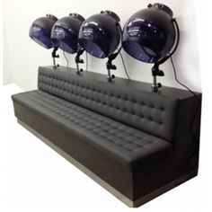 a couch with five black helmets on it's head and four lights above it