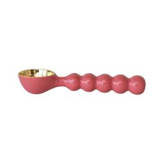 a pink object with gold in it on a white background