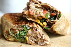 two burritos stacked on top of each other with meat and vegetables in them