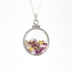 "Autumn inspired handcrafted brand new sterling silver multi-gem shaker locket! This statement pendant is nickel sized with coin style bezels, and clear lucite covers. The round charm hangs from a brand new sterling silver chain, and is filled with a mixture of genuine rubies, white topaz, and yellow sapphires. A fall inspired piece of brand new jewelry, featuring July's birthstones! ERA - New METAL / MATERIAL - Sterling silver locket & chain, lucite clear covers, 1 screw (can be opened and Sterling Silver Medallion With Birthstone Jewelry, Heirloom Sterling Silver Medallion Necklace, Silver Medallion Birthstone Jewelry, Unique Coin-shaped Pendant Jewelry, Silver Medallion Jewelry With Birthstone, Spiritual Sterling Silver Round Pendant Gemstone, Heirloom Style Sterling Silver Medallion Necklace, Memorial Jewelry With Round Gemstone Pendant, Unique Round Coin Pendant Jewelry